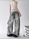 Trendy high-waist wide-leg ripped jeans for women with tie-dye and distressed detailing, perfect for casual street style.