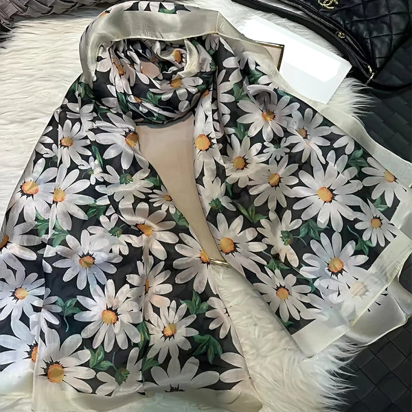 Model wearing Autumn Whisper silk scarf at a coffee shop, embodying serene elegance.