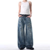 Trendy washed and ripped wide-leg women's jeans with distressed ink-splashed finish for a chic casual look.