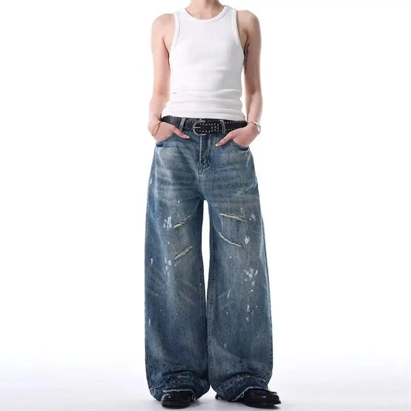 Trendy washed and ripped wide-leg women's jeans with distressed ink-splashed finish for a chic casual look.