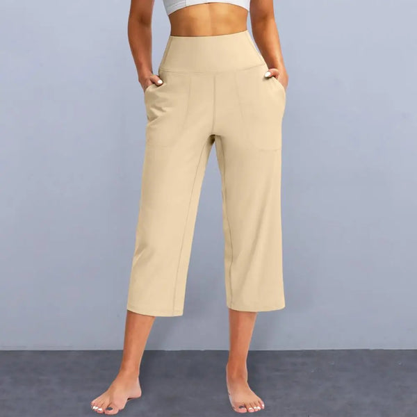 Chic high-waist wide-leg capri yoga pants with pockets, perfect for activewear and casual outings in nylon-spandex blend.