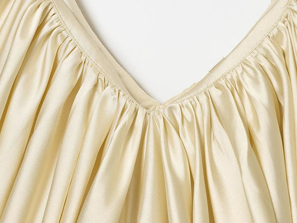 Backless slip top with textured pleating and sophisticated V-neckline