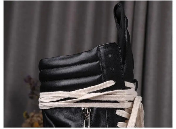 Midnight Ride Leather Boots against a backdrop of city lights.