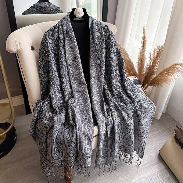 Large paisley pashmina shawl laid flat, highlighting its luxurious feel.