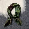 Elegant green satin scarf with unique print, perfect for all seasons.