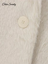 Side view of white mohair blazer displaying functional pockets and elegant button detailing