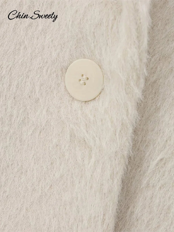 Side view of white mohair blazer displaying functional pockets and elegant button detailing