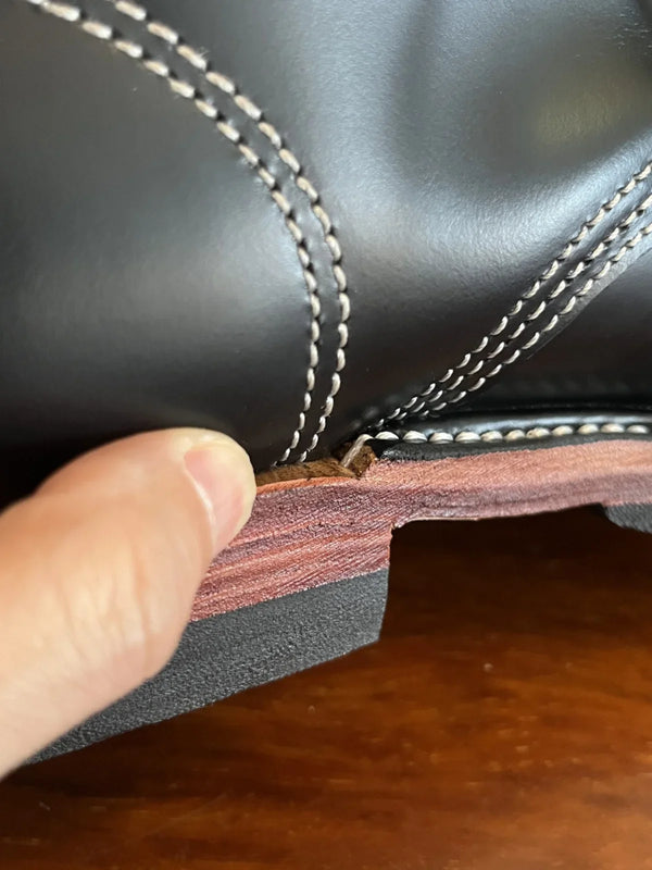 Side view of stylish men's boots featuring a classic round toe design.