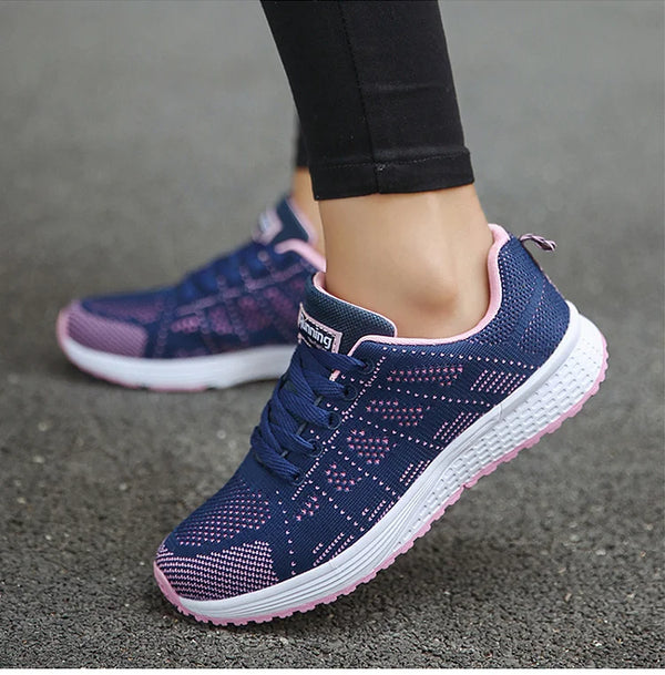 Breathable white athletic footwear with colorful accents and rubber outsole