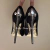 Back view of slip-on style crystal-embellished stiletto pumps.