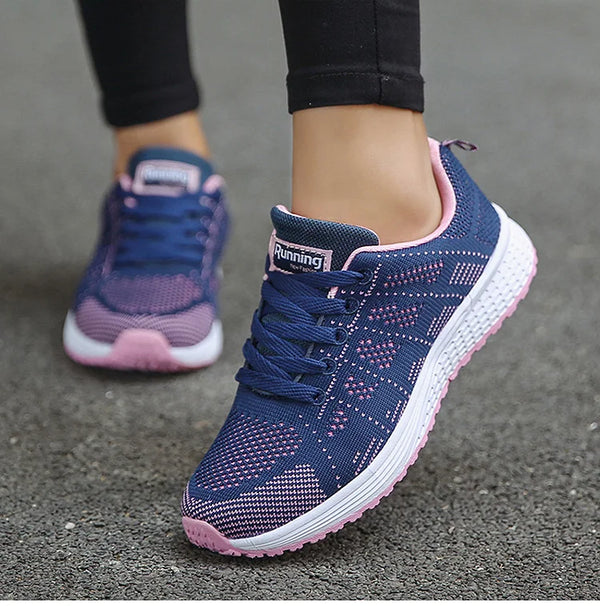 Women's cushioned white sports shoes with multi-color design elements