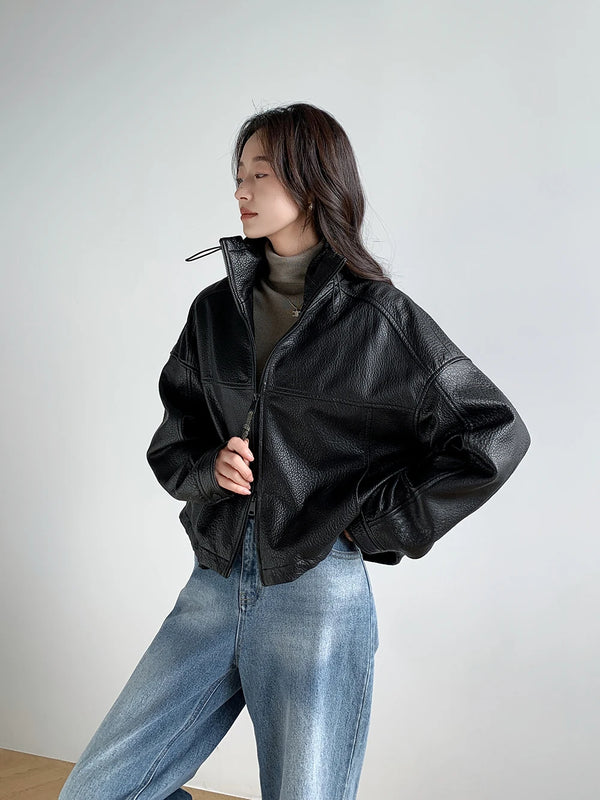 Chic vintage leather cropped jacket for women paired with elegant accessories.