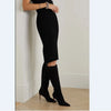 Brown knee-high stiletto boots, ideal for night outs.