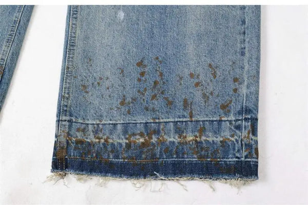 Trendy washed and ripped wide-leg women's jeans with distressed ink-splashed finish, mid-rise, and zipper fly closure.