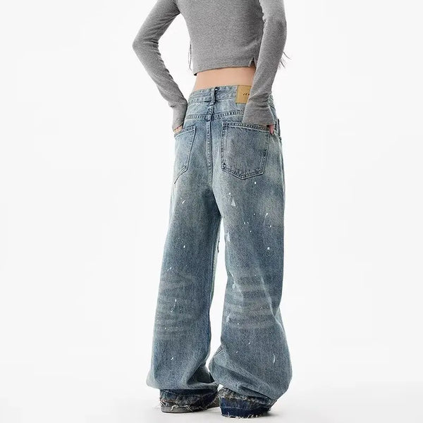 Trendy washed and ripped wide-leg women's jeans with ink-splashed finish and mid-rise design for stylish casual wear.