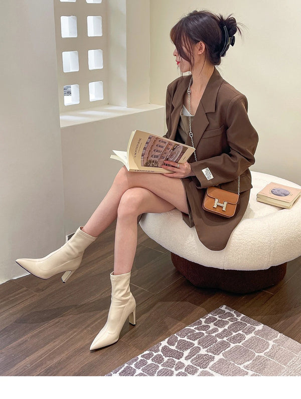 Chic black ankle boots with slim high heels, pointed toe design, perfect for autumn and winter fashion. Stylish slip-on footw