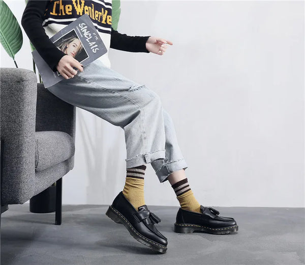 Black tassel loafers with a sophisticated silhouette for any occasion.