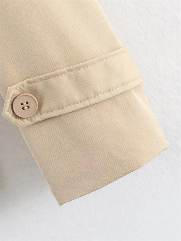 Beige short trench coat with classic belt and button styling