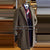 Classic men's brown herringbone trench coat with notched collar and single-breasted design.