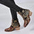 Statement embroidered boots combining bohemian charm with modern block heel silhouette