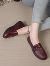 Detail shot of flower-embellished leather loafer with cushioned comfort insole