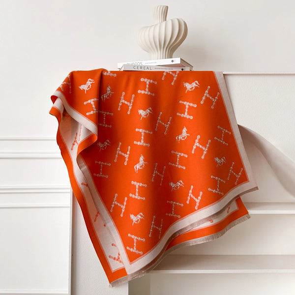 Warm winter scarf in rich cashmere, adorned with vibrant floral motifs.