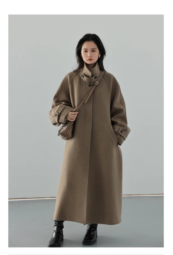 Versatile long trench coat featuring wool construction and flattering belt detail