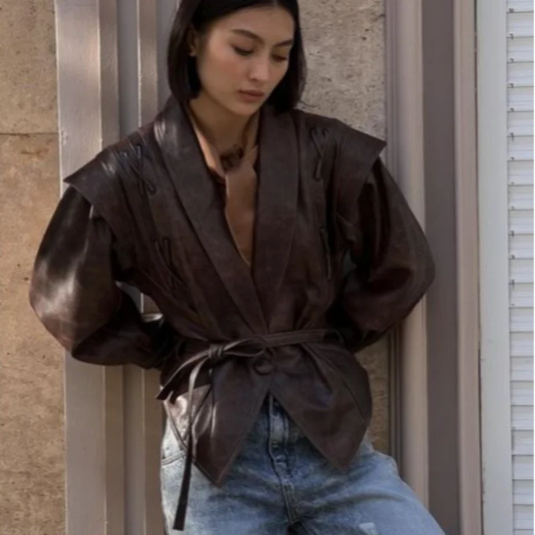 Chic belted leather bomber jacket for women, featuring lace-up detail, hood, and notched lapel, perfect for autumn and winter