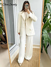 Close-up of creamy white mohair blazer fabric showing soft, luxurious polyester texture and quality construction