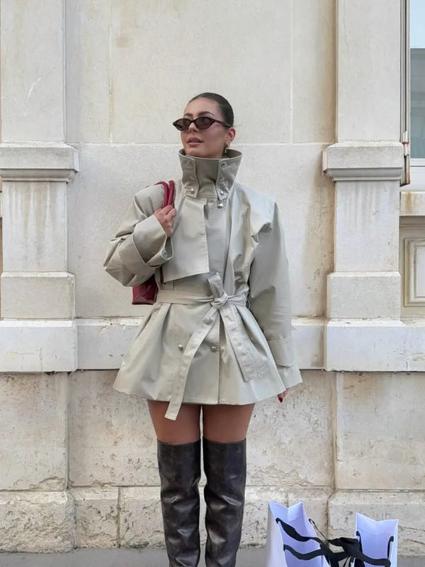 Khaki trench coat with stand collar and double-breasted button front on white background