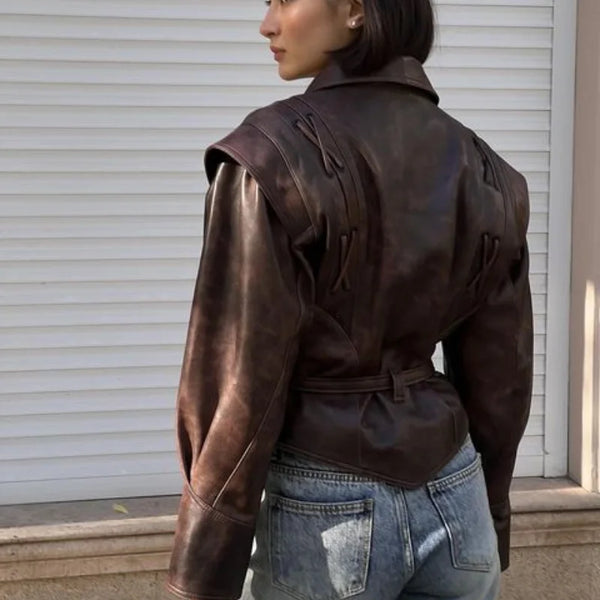 Chic belted leather bomber jacket for women, featuring lace-up detail, hood, and notched lapel, perfect for autumn and winter