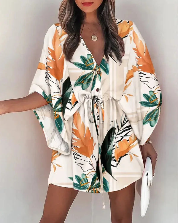 Floral boho V-neck dress with ruffle irregular hem and button front detail on white background