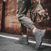 Winter Vanguard boots on icy sidewalk, highlighting weather-resistant features.