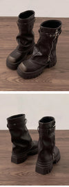 Chic women's mid-calf biker boots with buckle detail, cozy plush lining, and durable rubber sole for stylish winter wear.