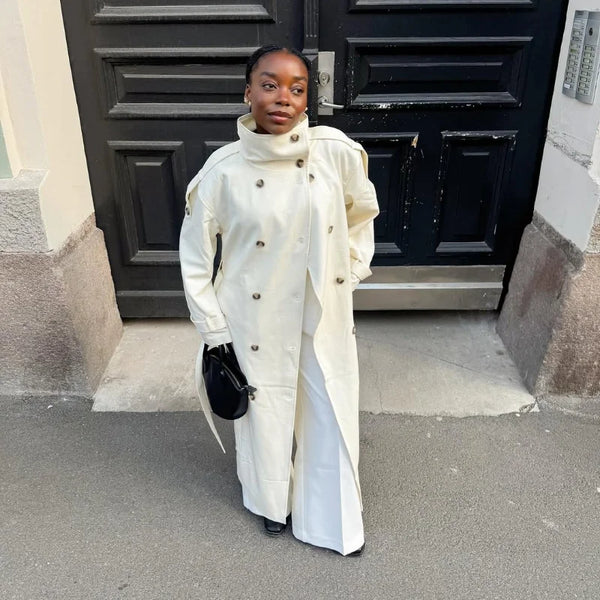 Timeless cream trench coat back view displaying long length and elegant drape