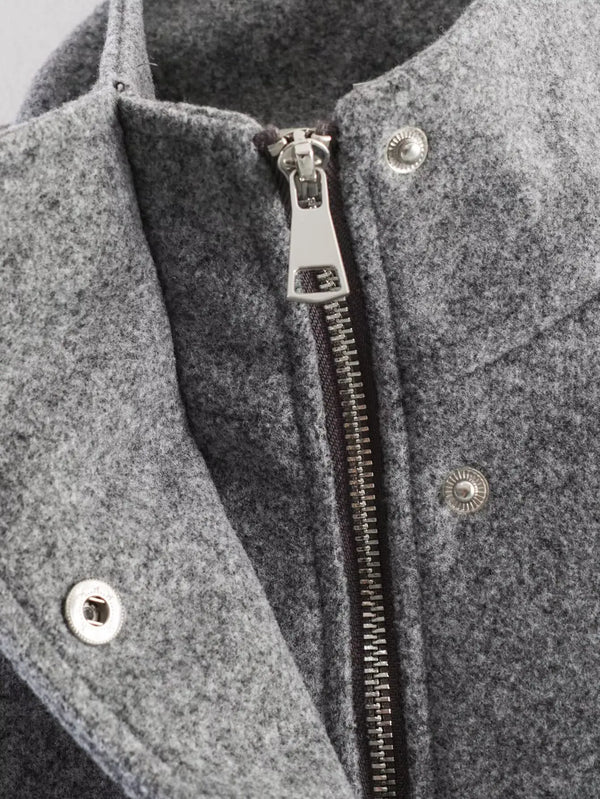 Women's polyester jacket showing belted waist detail and turtleneck collar
