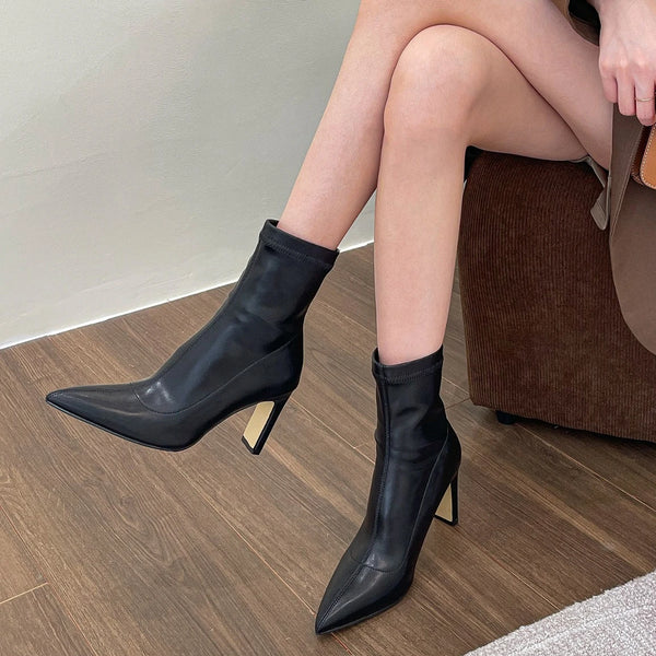 Chic black ankle boots with slim high heels, pointed toe design, perfect for autumn and winter fashion. Stylish slip-on footw