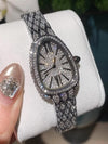 Elegant diamond-studded watch showcasing precision craftsmanship and luxury.