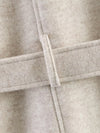 Belted outerwear featuring turtleneck collar and versatile neutral color