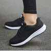 White lace-up sneakers with multi-color accents and cushioned comfort