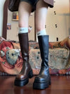 Chic black platform knee-high fashion boots with wedge heel, waterproof design, and bling accents for stylish women.
