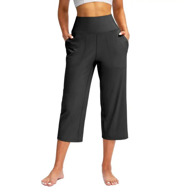 Chic high-waist wide-leg capri yoga pants with pockets, perfect for activewear and casual outings in nylon-spandex blend.