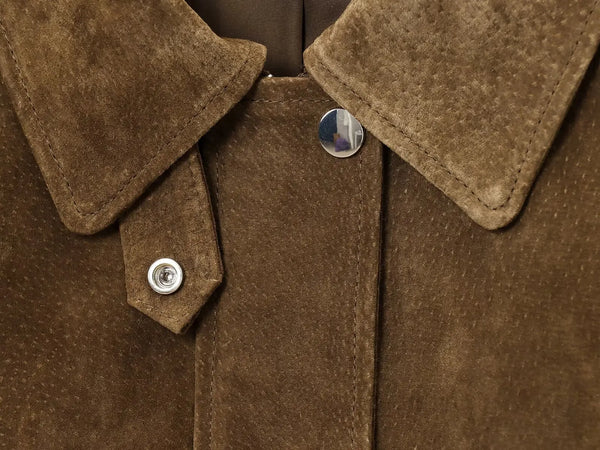 Chic women's leather jacket with button closure, lapel collar, and short length for stylish urban fashion and versatility.