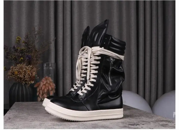 Back view of black leather boots with subtle lace-up detail.