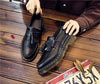 Stylish black tassel loafers with a breathable leather upper.