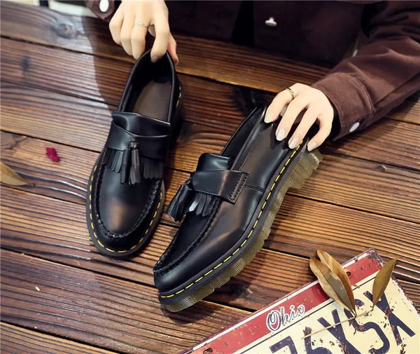 Stylish black tassel loafers with a breathable leather upper.