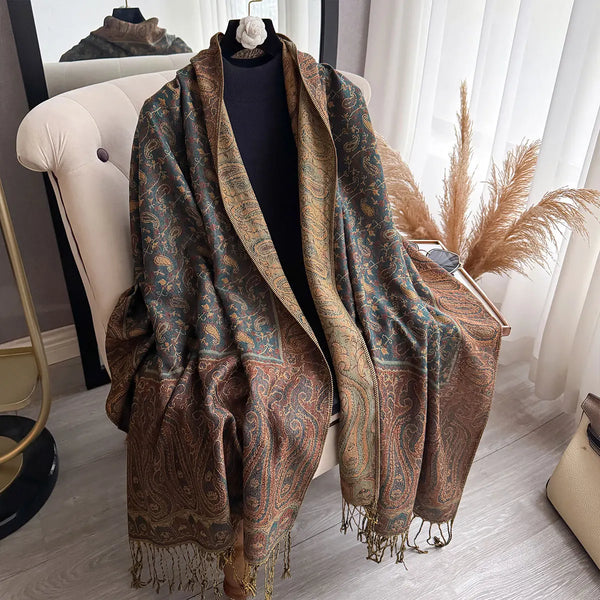 Lightweight paisley pashmina scarf draped over shoulders, showcasing tassels.