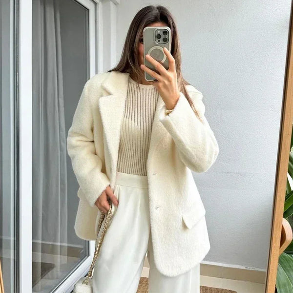 Creamy white mohair blazer paired with tailored trousers for sophisticated office look