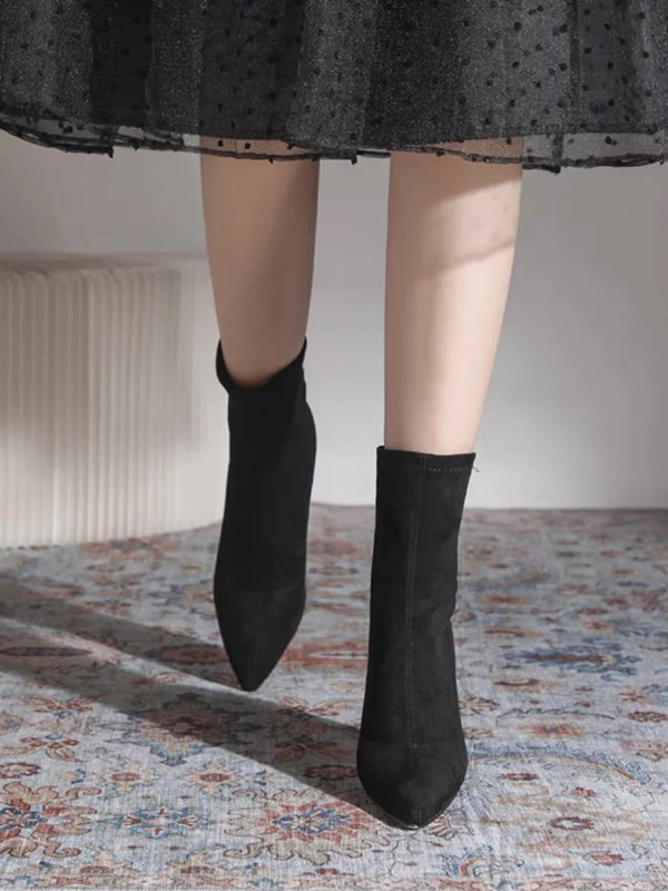 Chic black ankle boots with slim high heels, pointed toe design, perfect for autumn and winter fashion. Stylish slip-on footw