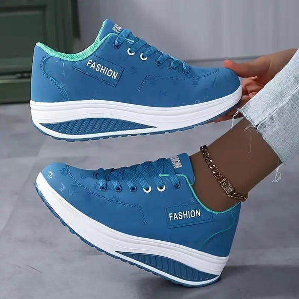 Close-up of platform wedge sneaker lace-up detail and PU upper